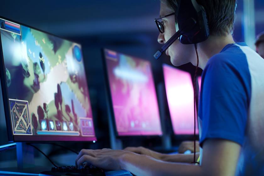 Team of Professional eSport Gamers Playing in Competitive MMORPG/ Strategy Video Game on a Cyber Games Tournament. They Talk to Each other into Microphones. Arena Looks Cool with Neon Lights.