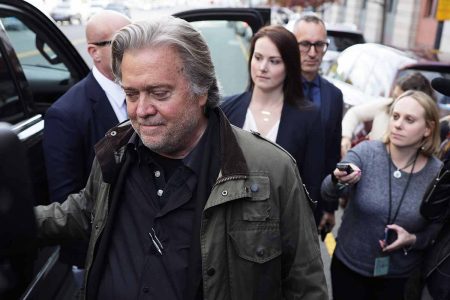 Steve Bannon, ex-assessor e marketeiro do ex-presidente dos EUA, Donald Trump. Ele aparee sendo conduzido por policiais perto de carro após ser preso por fraude. Atrás, jornalistas tentam o entrevistar - Metrópoles