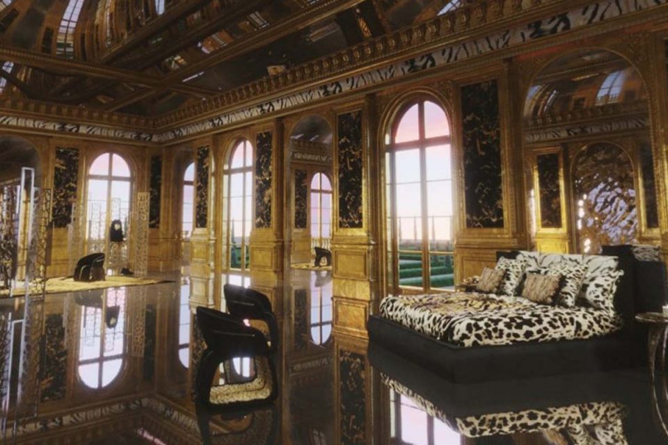 Quarto escuro com paredes douradas. No ambiente há uma cama preta com roupa de cama de onça. Há ainda pequenas poltronas, também na cor preta.