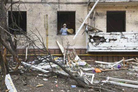 Moradores de um apartamento em prédio residencial no bairro residencial de Kiev, depois de ter sido atingido por bombardeios no início da manhã em kiev ucrania