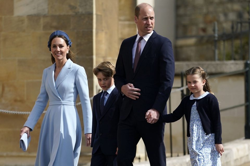 Foto colorida. Kate Middleton, príncipe George, príncipe William e princesa Charlotte de mãos dadas
