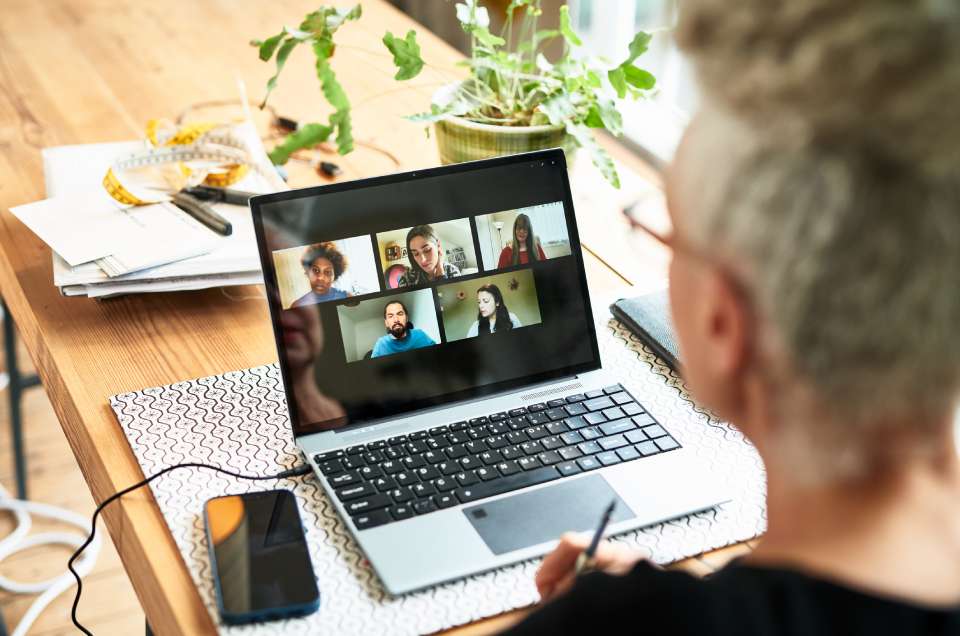 Na foto, há um homem em frente a um lap top conversando de forma on-line com outras pessoas - Metrópoles