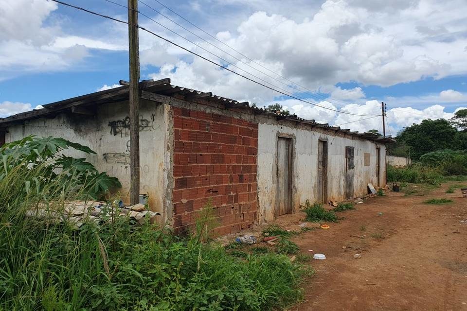 Casa velha com mato em volta