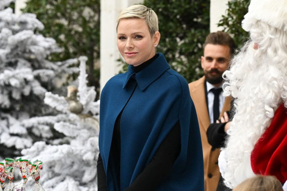 Foto colorida de mulher branca, loira e com cabelos curtos. Ela veste um casaco azul - Metrópoles