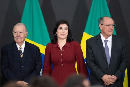 A cerimônia de posse da ministra do Planejamento e Orçamento, Simone Tebet, realizada no Salão Nobre do Palácio do Planalto. Na foto, a ministra aparece ladeada por José Sarney e Geraldo Alckmin no palco, com bandeiras do Brasil atrás - Metrópoles