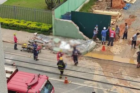 Imagem mostra o momento em que os bombeiros atuam na ocorrência em que um muro caiu sobre um trabalhador, o matando - Metrópoles