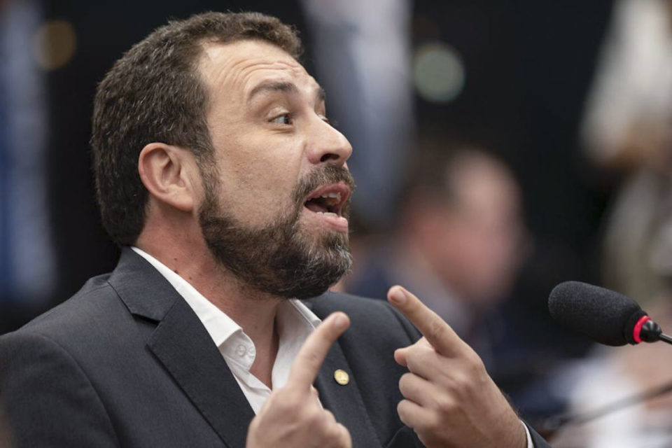 Imagem colorida de Guilherme Boulos, homem branco, de cabelo e barba aparada castanha, gesticulando com as mãos - Metrópoles