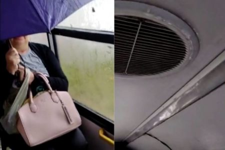 Imagem mostra mulher se protegendo da chuva em um ônibus - Metrópoles