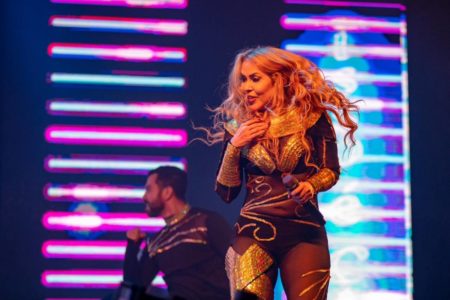 Foto colorida de Joelma durante show em Brasília. Ela está usando uma roupa escura - Metrópoles