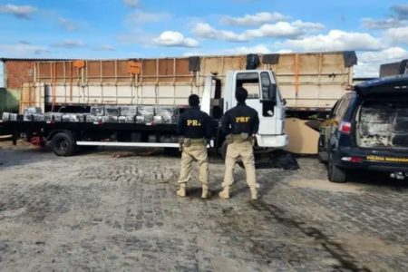 Na foto, dois agentes da PRF em frente a um caminhão - Metrópoles