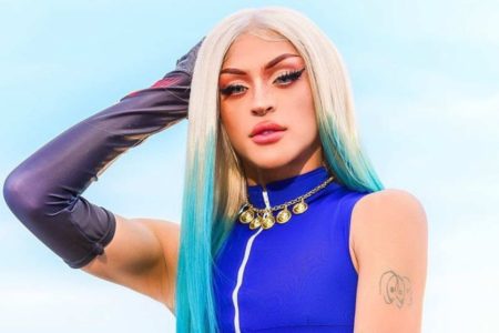 Foto colorida de Pabllo Vittar com um fundo azul - Metrópoles