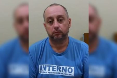 Homem de meia idade de camiseta azul escrita "interno"
