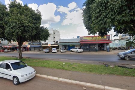 Rua com carro branco e árvores