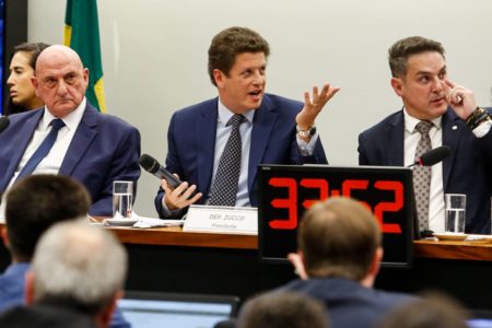 imagem colorida mostra sessão da cpi do mst com deputados sentados em frente a computadores e deputado ricardo salles com microfone na mão