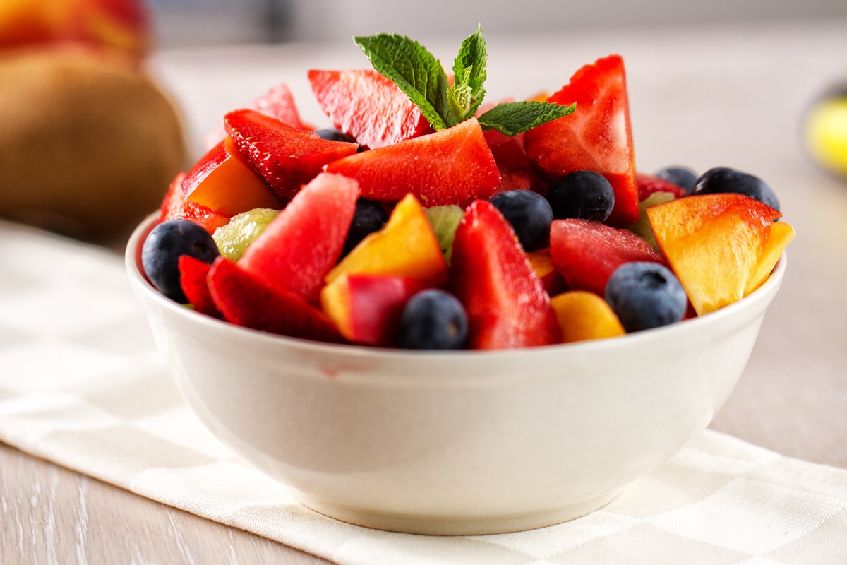 Foto colorida. Imagem mostra um pote branco com vários tipos de frutas - Metrópoles