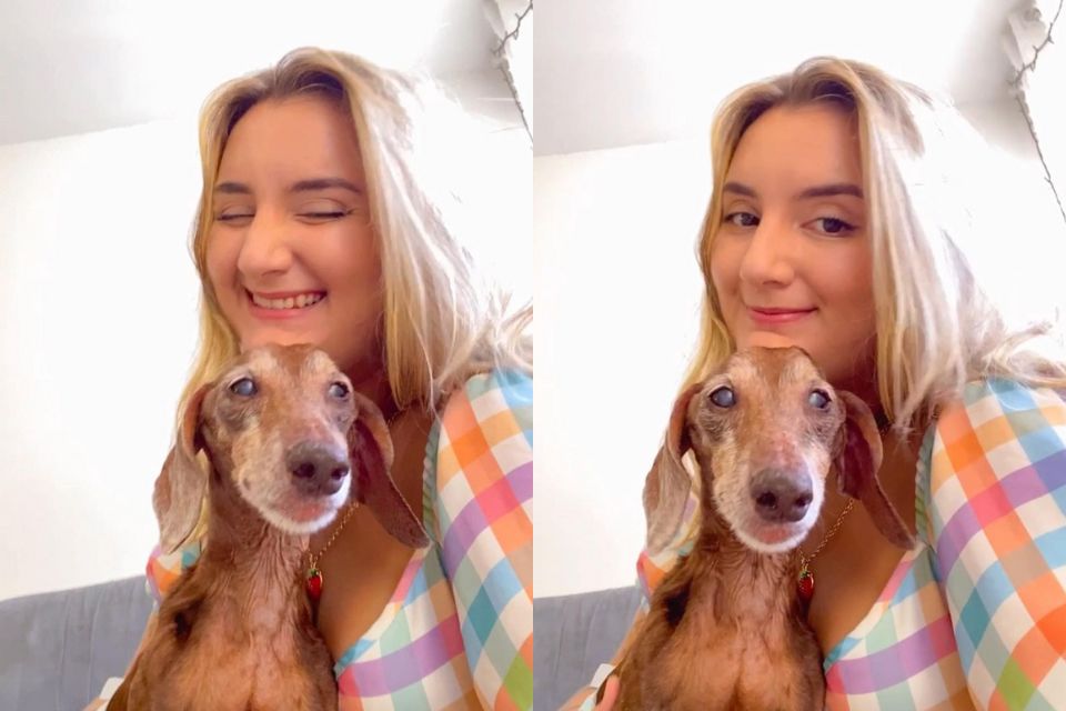 Foto colorida de uma mulher loira segurando um cachorro - Metrópoles