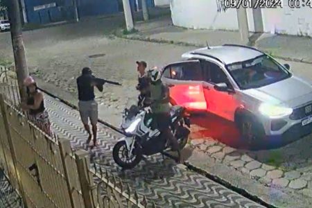 Imagem colorida mostra ladrões usando fuzil para roubar moto em São Vicente
