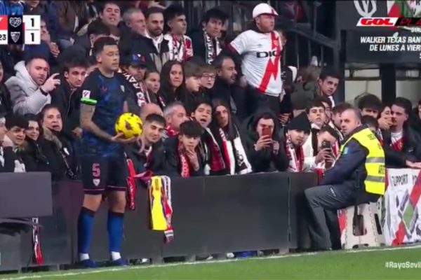 Imagem colorida do momento em que jogador do Rayo Vallecano é violaod por torcedor do Sevilla- Metrópoles