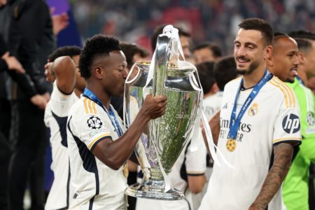 Imagem do jogador de futebol vini junior beijando a taça da champions league 2024