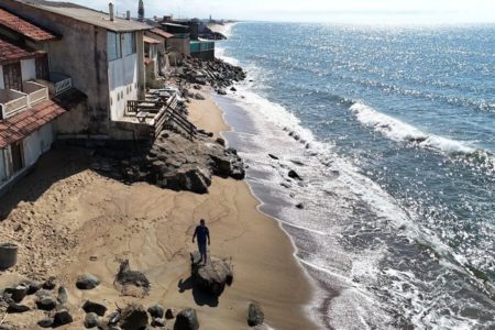 Imagem colorida de casas à beira-mar - Metrópoles
