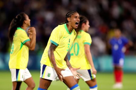 Imagem colorida de uma mulher gritando em comemoração | Brasil | Olimpíadas - Metrópoles