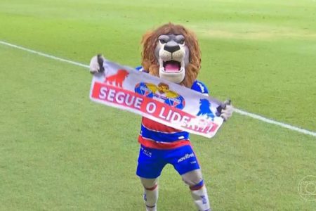 Mascote do Fortaleza segura cartaz escrito "segue o líder"