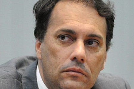 Foto de Atila Jacomussi, sem barba, cabelo preto e um olhar sério. Ele veste terno cinza- Metrópoles