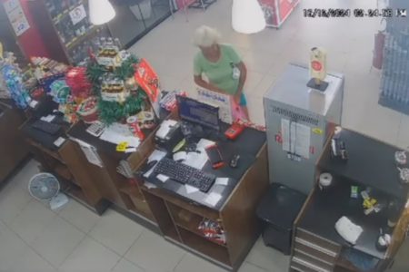 Captura de tela de câmeras de segurança que mostram momento em que mulher rouba caixinha de Natal. - Metrópoles