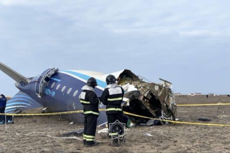 Foto colorida de resgate próximo aos escombros do avião que caiu no Cazaquistão - Metrópoles