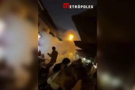 Imagem colorida de fumaça em meio a multidão em Pirenópolis - Metrópoles