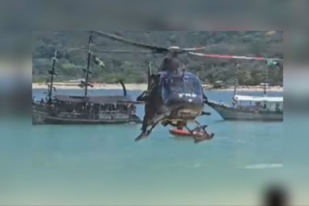 Imagens coloridas mostram helicóptero pousando em praia