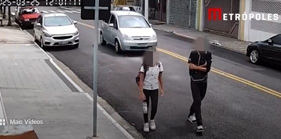 Imagem colorida de adolescente andando ao lado da irmã. Metrópoles