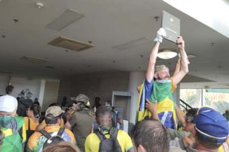 Vídeo STF Manifestantes bolsonaristas invadem e destroem o prédio do Supremo Tribunal Federal (STF). Os terroristas andam pelo ambiente interno e um deles, de pé, segura um exemplar da Constituição Federal - Metrópoles